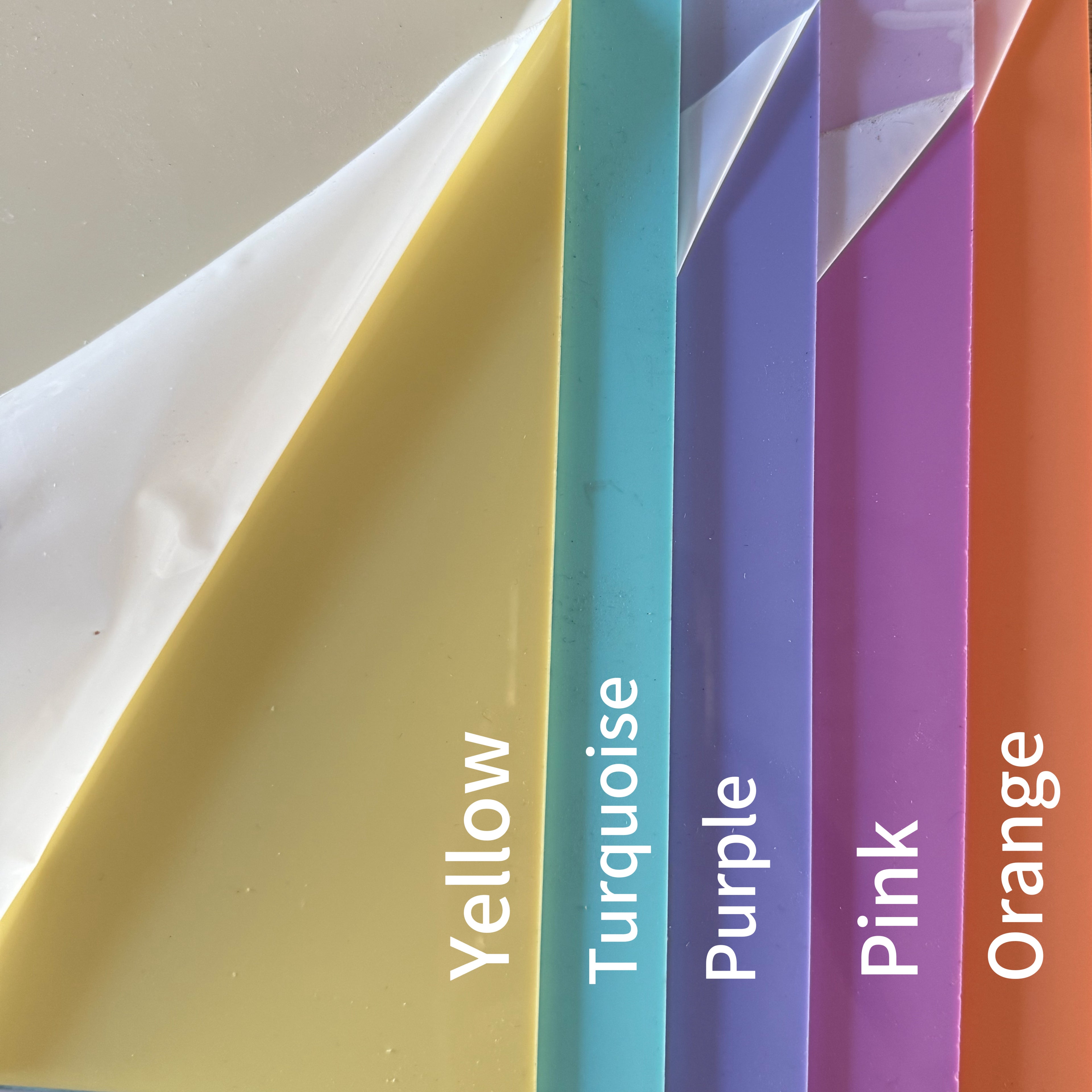 A collection of colorful plastic sheets, each with a different color name written on it.